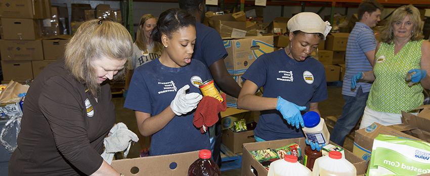 Alumni packing food boxes